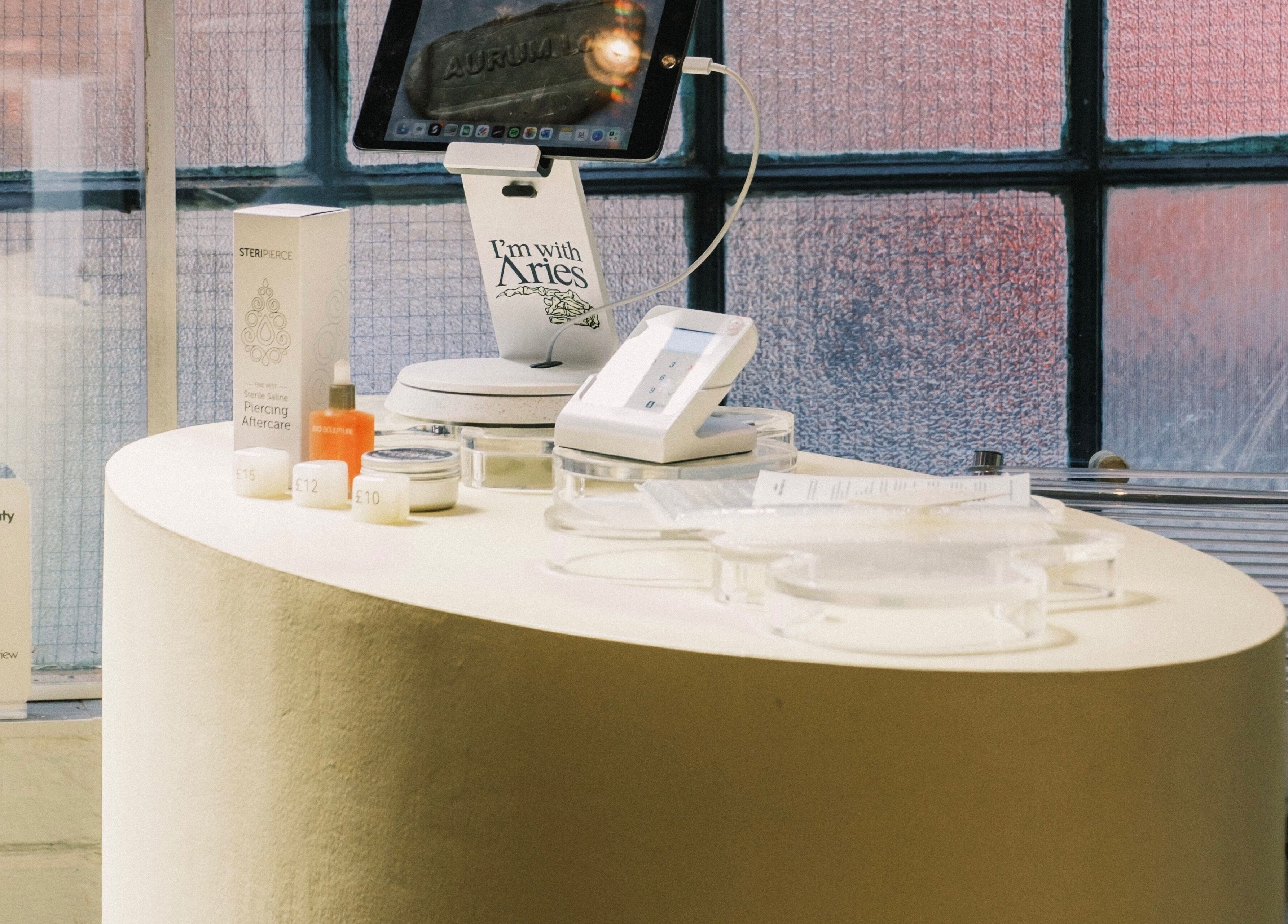 Reception counter at Milk Digits, London, England, GB showcasing beauty products and pricing.