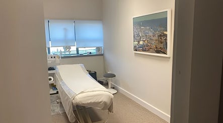 Calming treatment room at JKA Beauty Clinic, Bray, County Dublin, IE, featuring a bed, decor, and soft lighting.