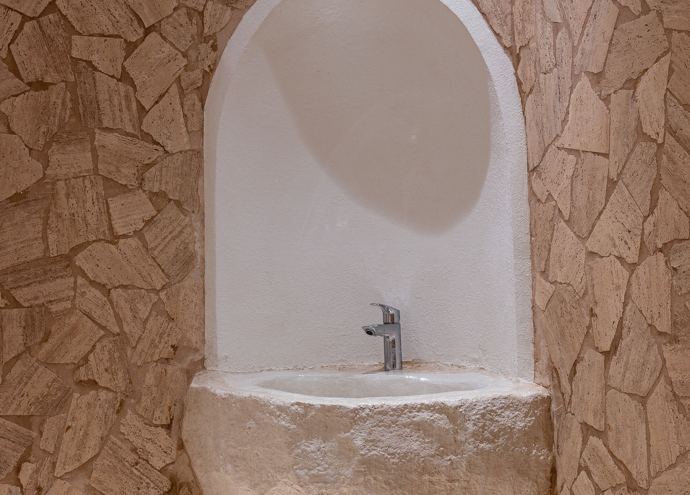 Elegant stone sink at Treat Men's Luxury Spa in Riyadh, Riyadh Province, SA exudes natural luxury.