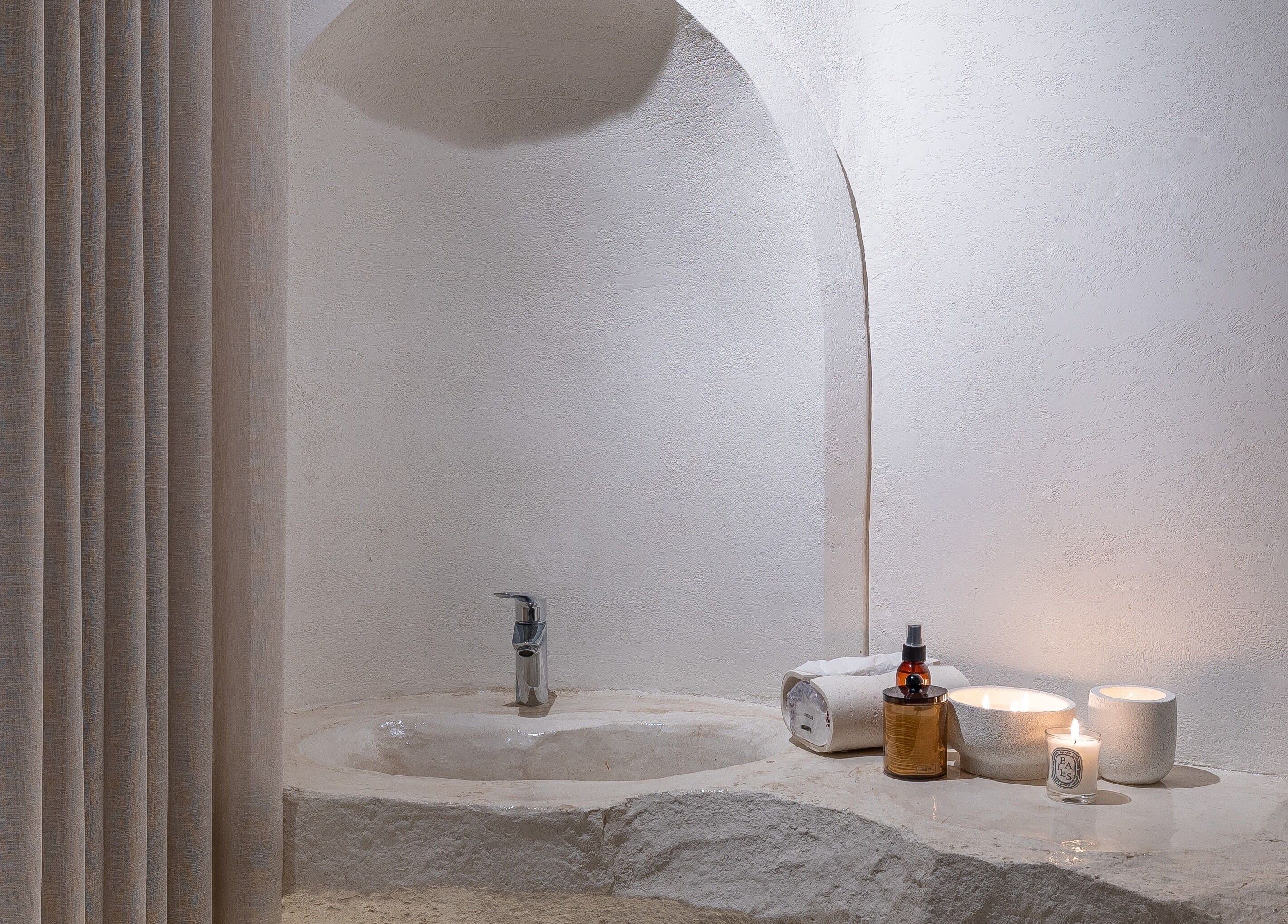 Elegant stone sink with candles at Treat Men's Luxury Spa, Riyadh, Riyadh Province, SA, radiating tranquility.