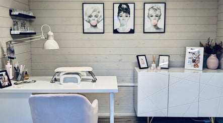 Chic nail salon interior at Gossip & Glamour, Chippenham, England, GB, with stylish decor and pop art portraits.