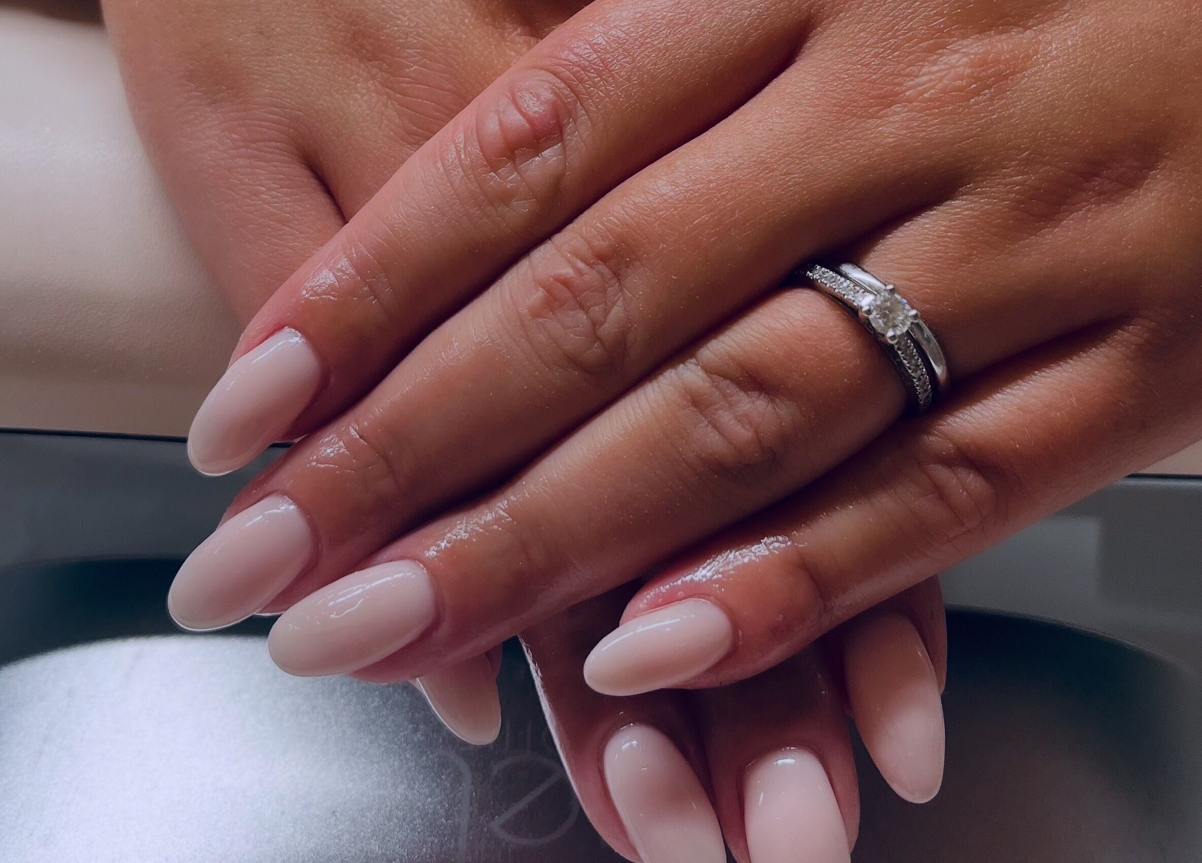 Manicured hands with rings at Gossip & Glamour, Chippenham, England, GB.