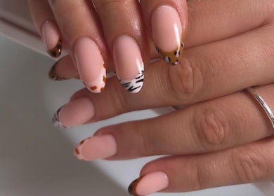 Stylish animal print nail art at Gossip & Glamour, Chippenham, England, GB. Perfect blend of modern nail trends.