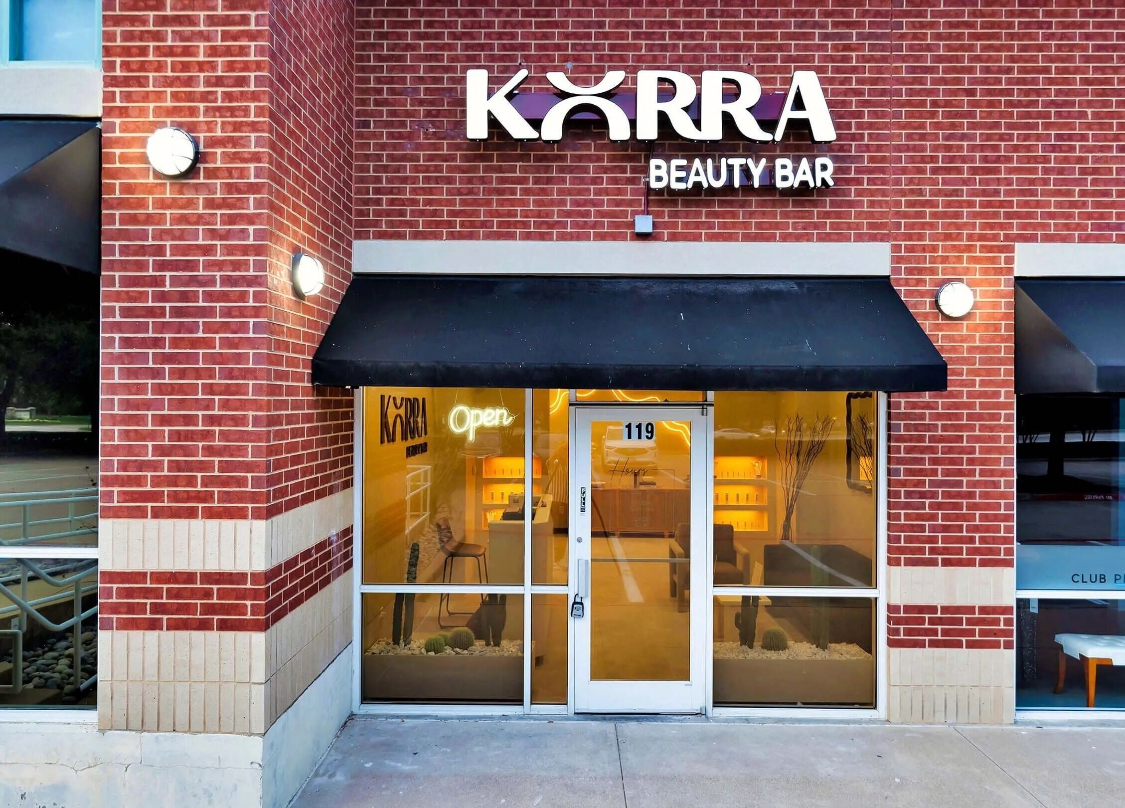 Korra Beauty Bar entrance with modern brick facade in Southlake, Texas, US.