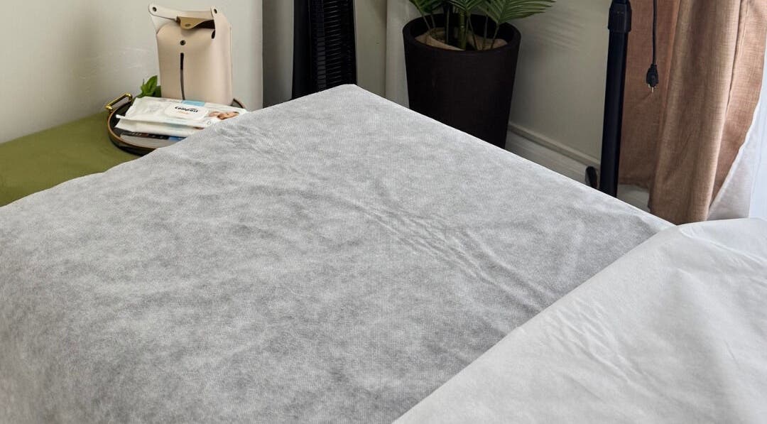 Cozy treatment bed at Lūmena Studios, Kingston, St. Andrew Parish, JM, perfect for relaxation and rejuvenation.