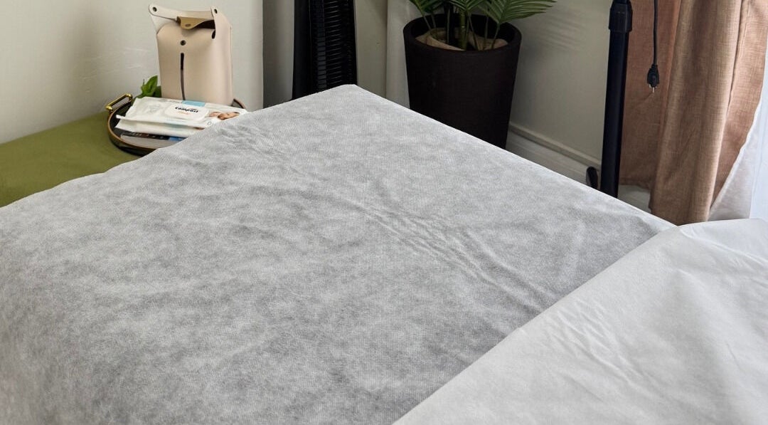 Cozy treatment bed at Lūmena Studios, Kingston, St. Andrew Parish, JM, perfect for relaxation and rejuvenation.