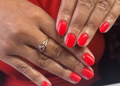 Radiant red manicure at Freyas Beauty, Bream, England, GB, showcasing nail artistry and elegance.