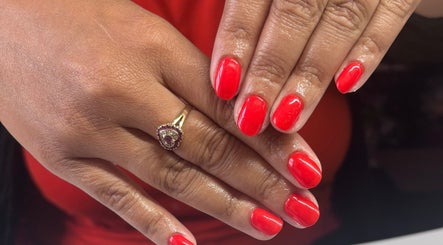 Radiant red manicure at Freyas Beauty, Bream, England, GB, showcasing nail artistry and elegance.