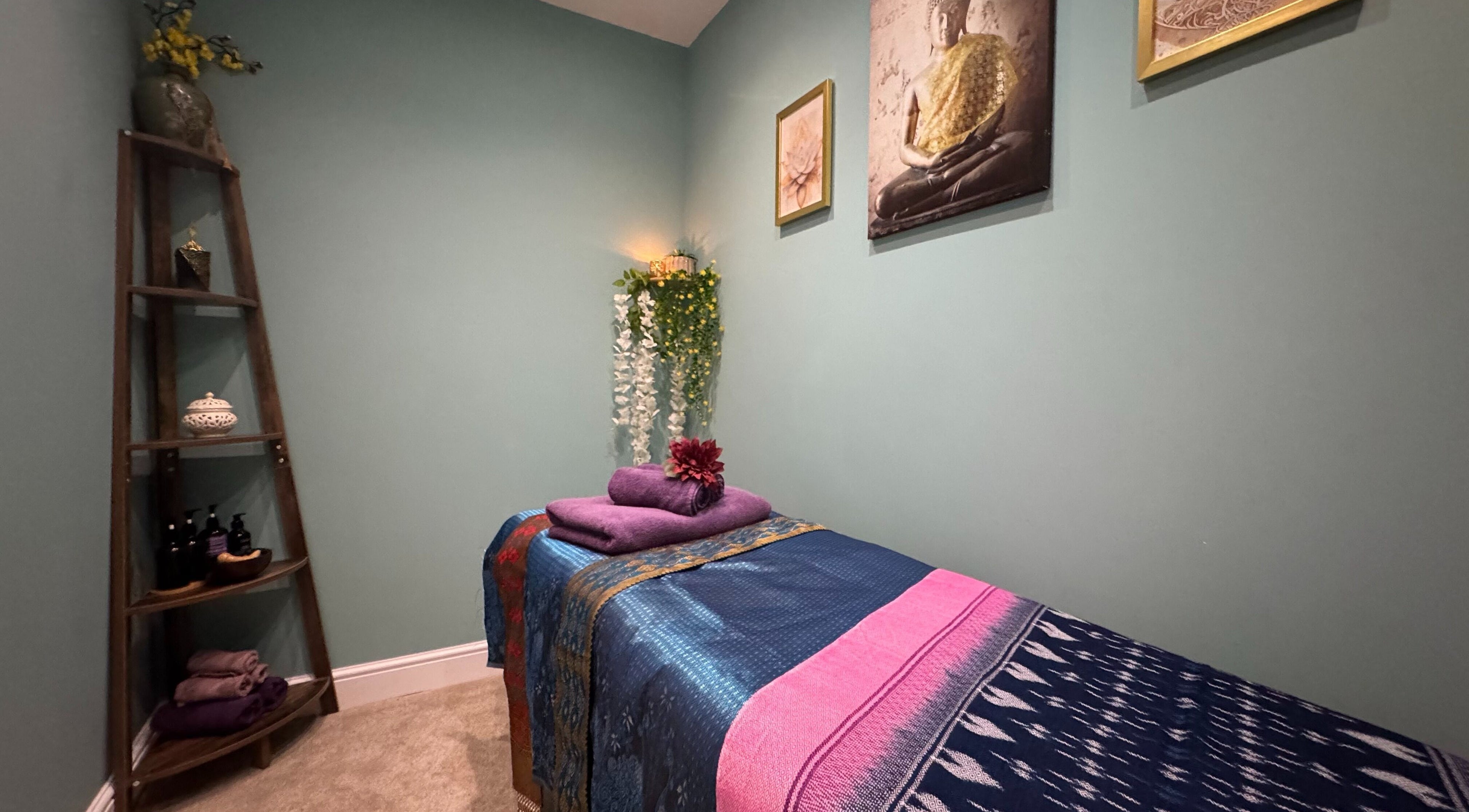 Serene massage room at Keena - Ladies Thai Massage, Lymm, England, GB, with a decorated treatment bed.