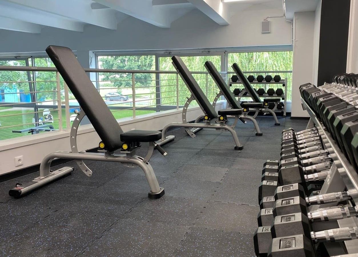 Modern gym with dumbbells and benches at Vantis Sporta un veselības centrs, Rīga, LV.