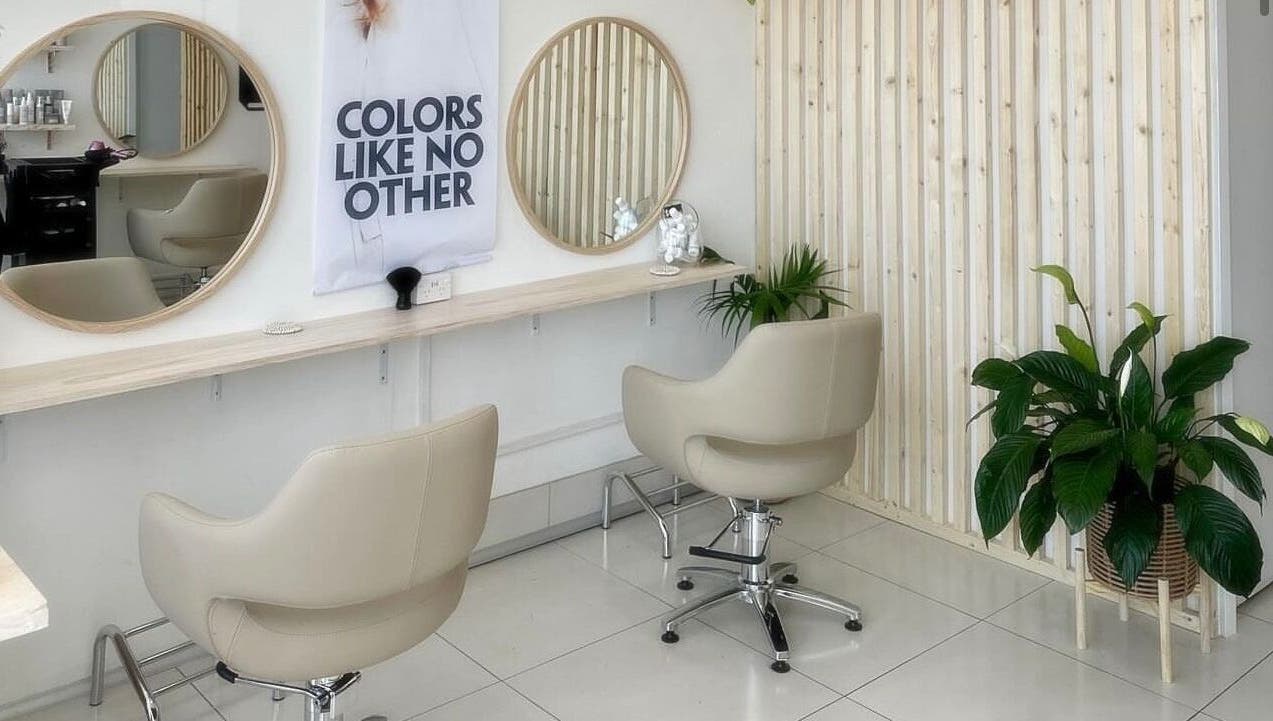 Modern salon chairs and mirrors at Tease by Laura, Budgewoi, New South Wales, AU, with elegant decor.