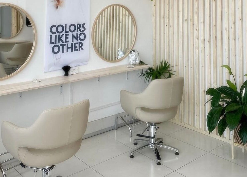 Modern salon chairs and mirrors at Tease by Laura, Budgewoi, New South Wales, AU, with elegant decor.