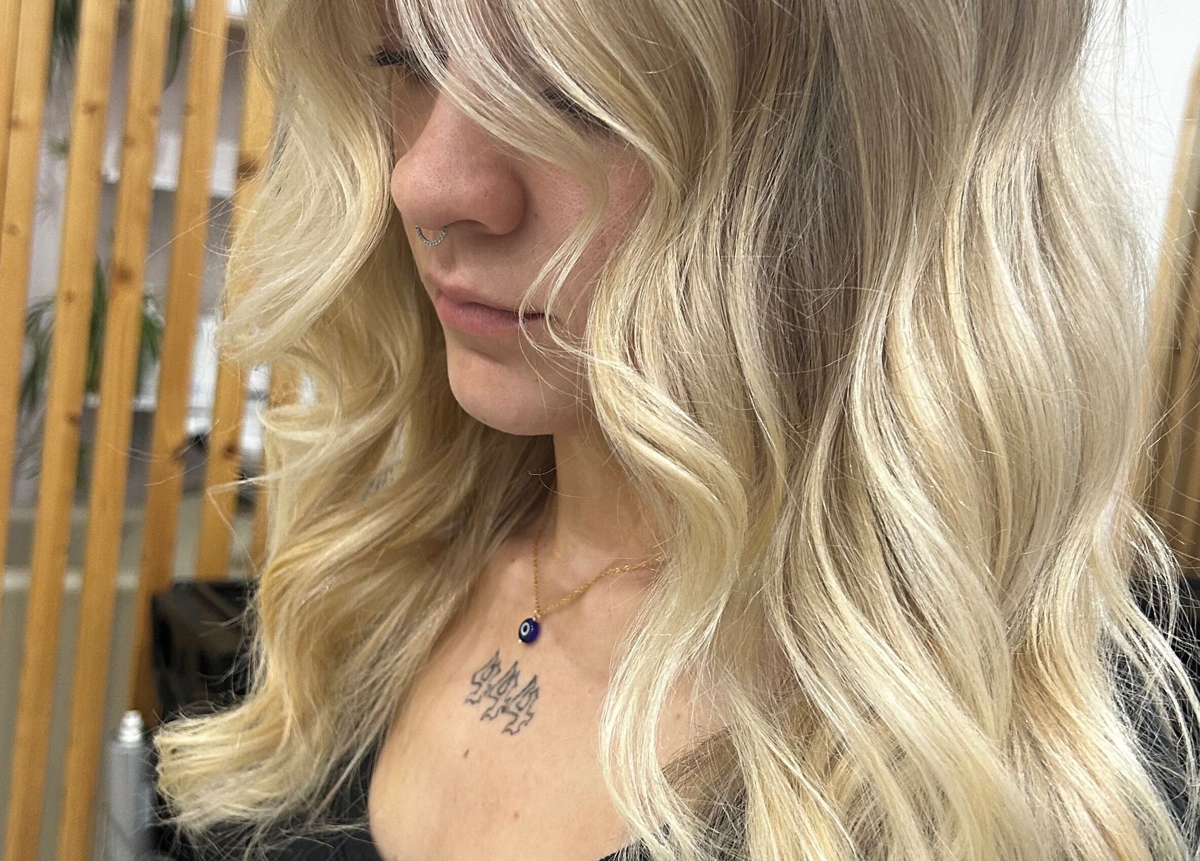 Elegant blonde hair styling at Tease by Laura, Budgewoi, New South Wales, AU, enhancing natural beauty.