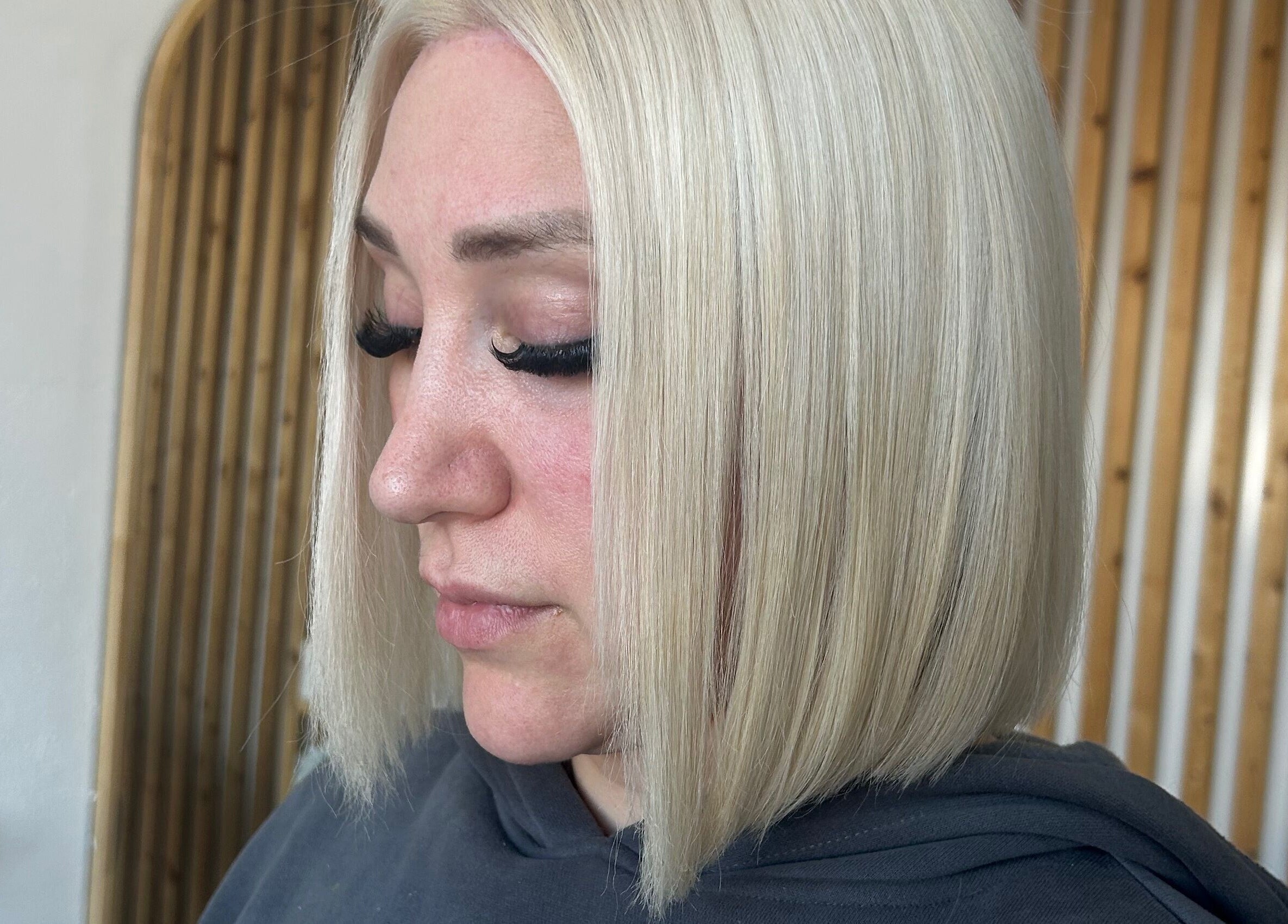 Close-up of stylish blonde bob haircut at Tease by Laura in Budgewoi, New South Wales, AU.