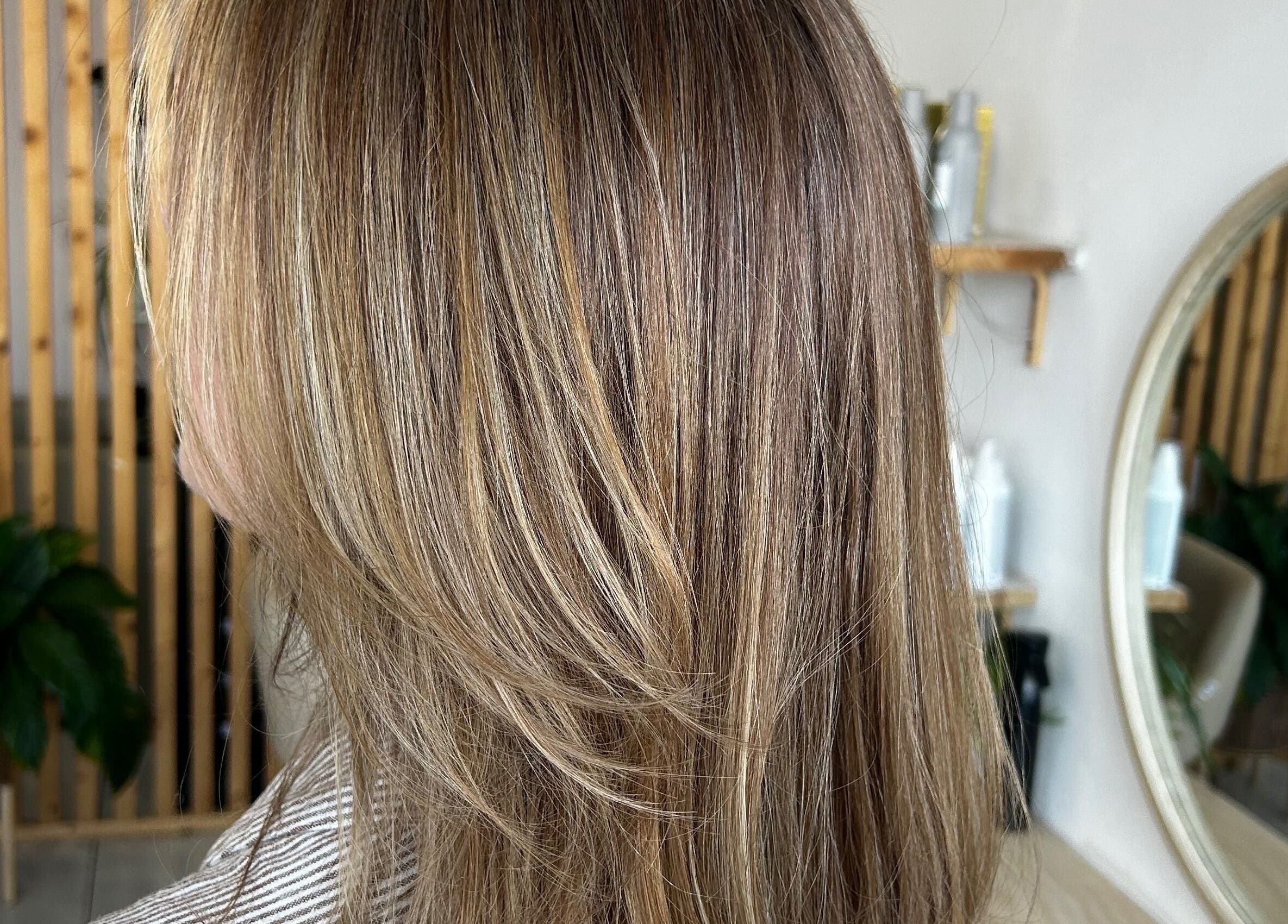 Stylish layered hair with sunlit highlights at Tease by Laura, Budgewoi, New South Wales, AU salon.