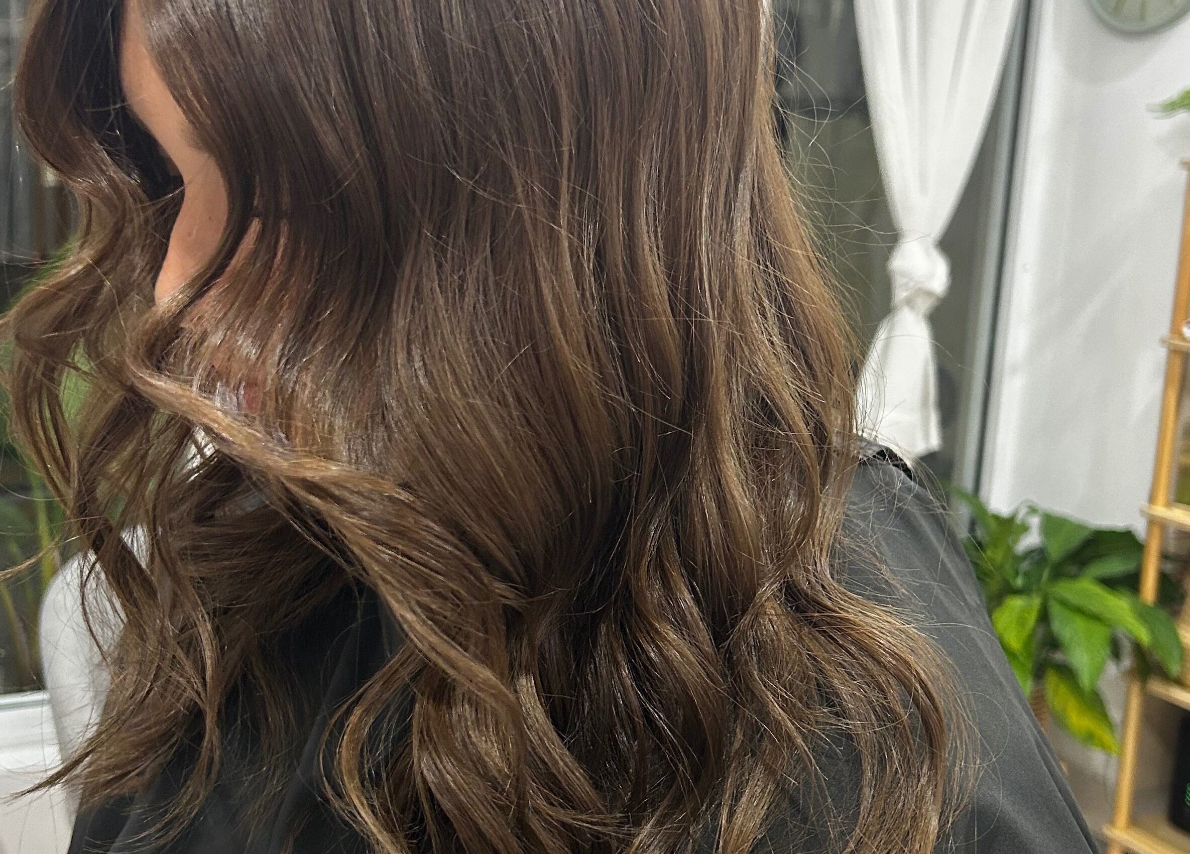 Elegant wavy hairstyle at Tease by Laura in Budgewoi, New South Wales, AU, perfect for a chic look.