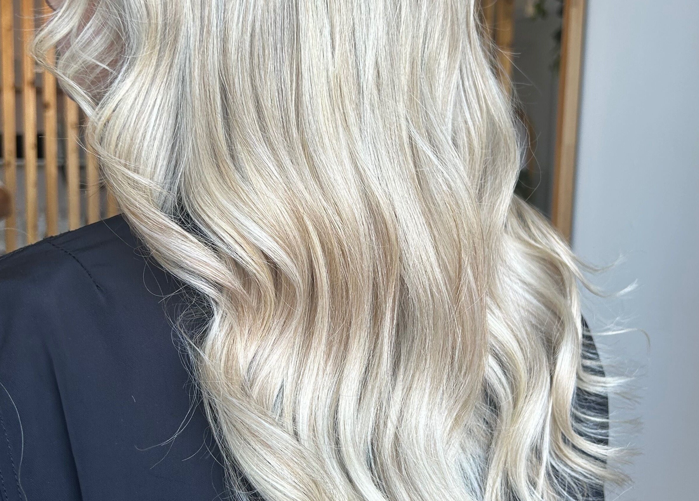 Blonde hair styled in soft waves at Tease by Laura, Budgewoi, New South Wales, AU.