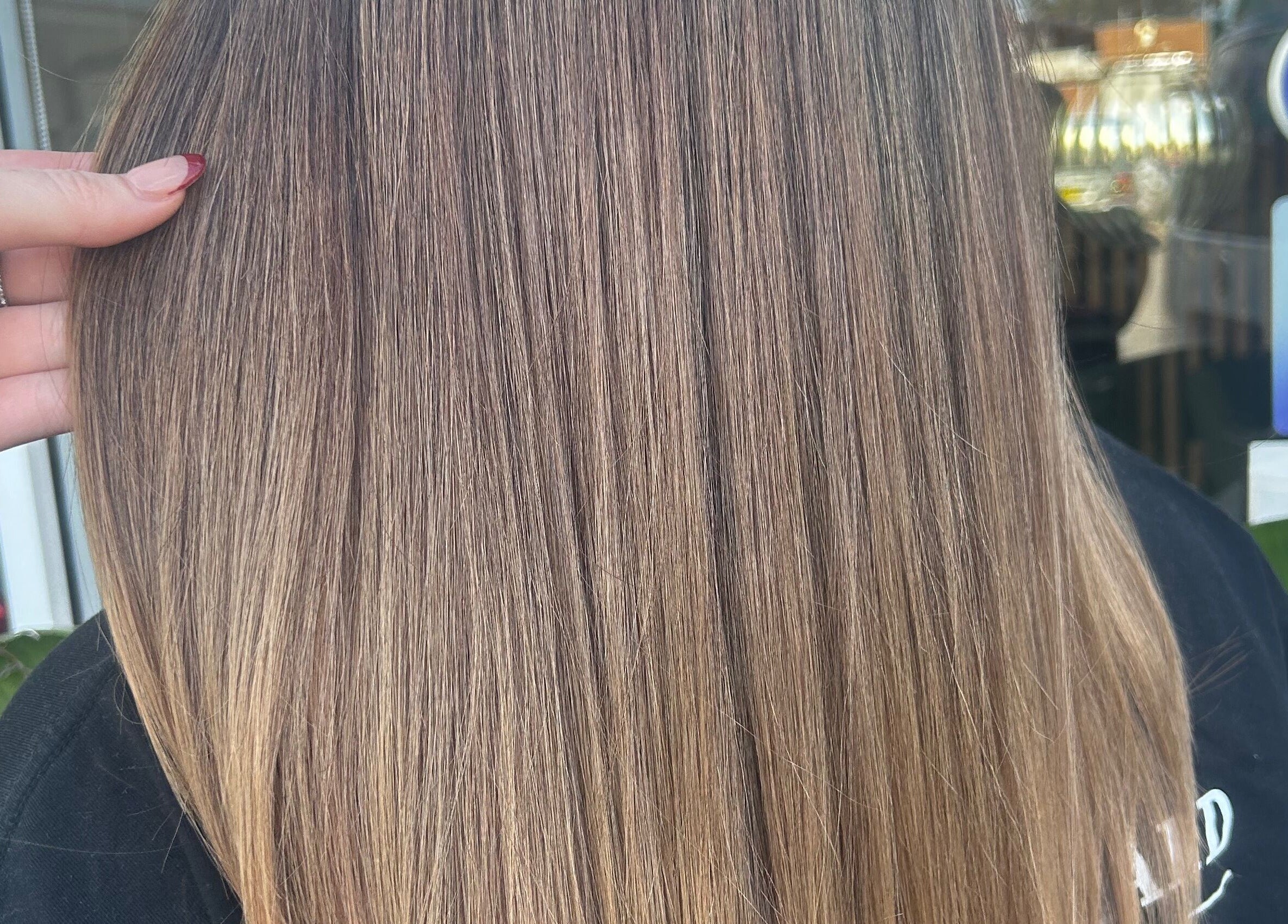 Sleek, shiny hair styled at Tease by Laura in Budgewoi, New South Wales, AU, highlighting impeccable hair care.