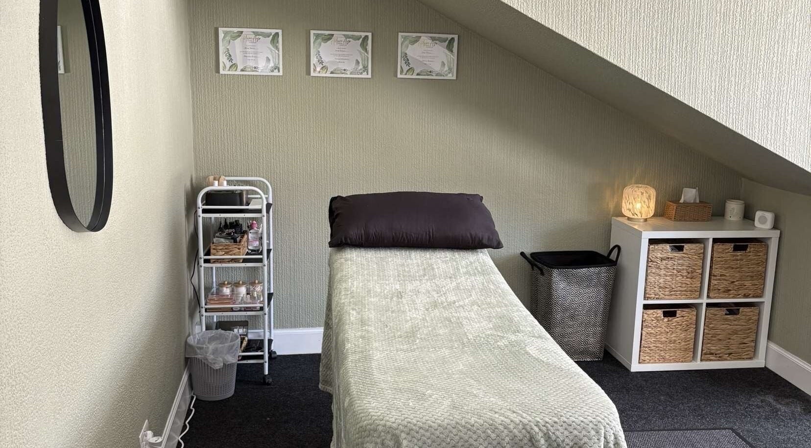 Cozy treatment room at Elliebbeauty, Dumfries, Scotland, GB, featuring a treatment bed and calming decor.