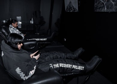 Comfortable relaxation chairs at Energize Recovery in Melbourne, Victoria, AU featuring therapy leg sleeves.