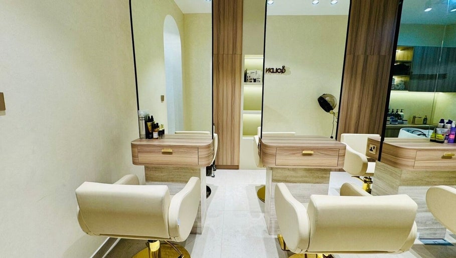 Chic interior of Goldn Muse Beauty Salon, Dubai, Dubai, AE showcasing sleek salon chairs and modern decor.