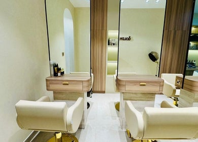 Chic interior of Goldn Muse Beauty Salon, Dubai, Dubai, AE showcasing sleek salon chairs and modern decor.