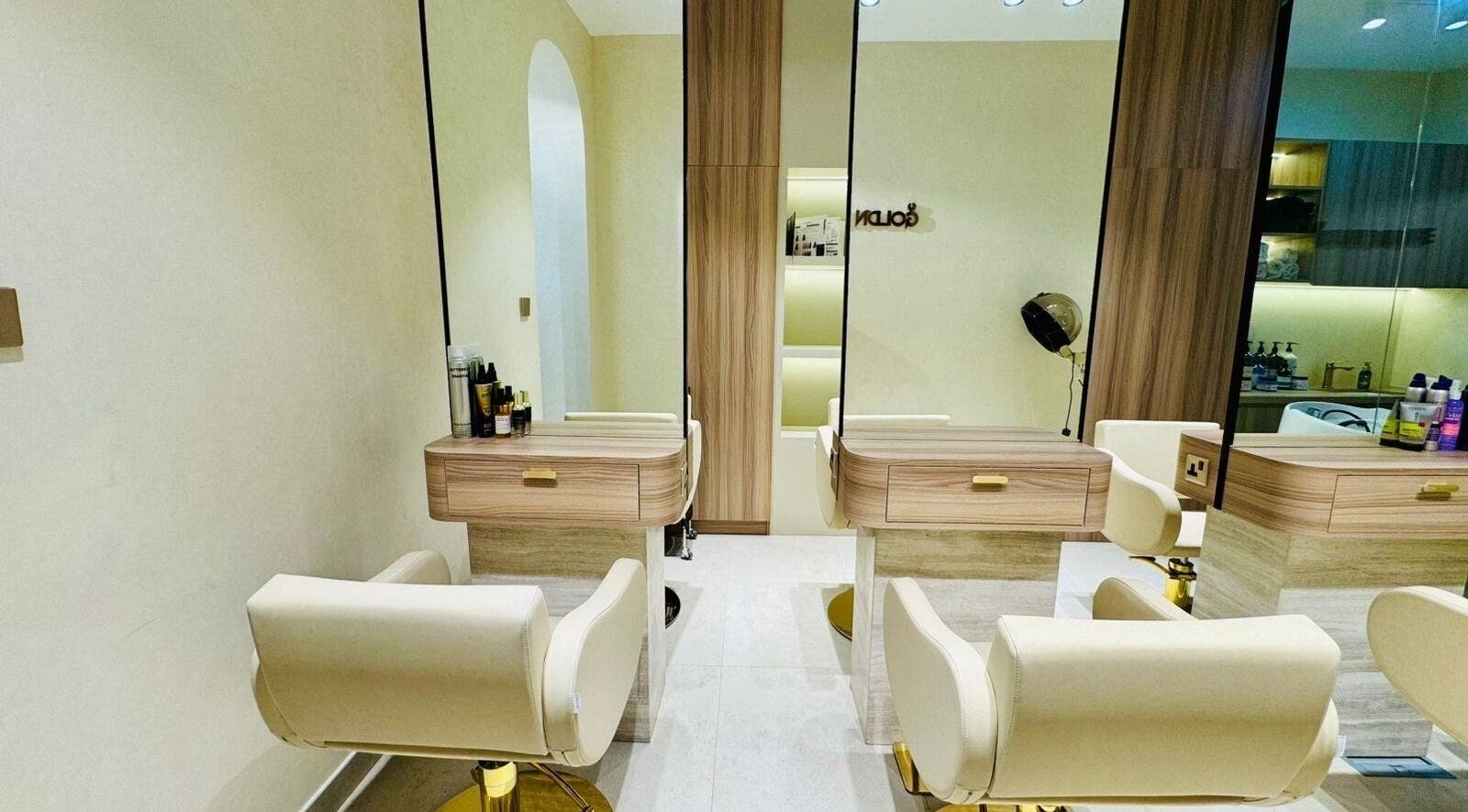 Chic interior of Goldn Muse Beauty Salon, Dubai, Dubai, AE showcasing sleek salon chairs and modern decor.