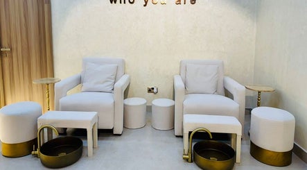 Relaxing pedicure station at Goldn Muse Beauty Salon, Dubai, Dubai, AE with plush seating and gold accents.