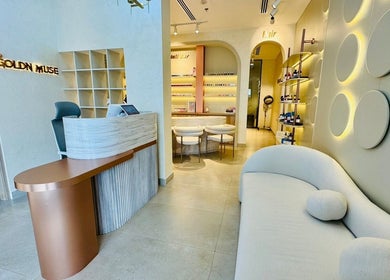 Sophisticated interior of Goldn Muse Beauty Salon, Dubai, Dubai, AE, showcasing a chic reception and cozy seating.
