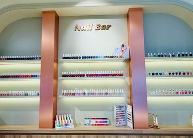 Diverse nail polish collection at Goldn Muse Beauty Salon, Dubai, Dubai, AE. Shelves stocked with colorful options.