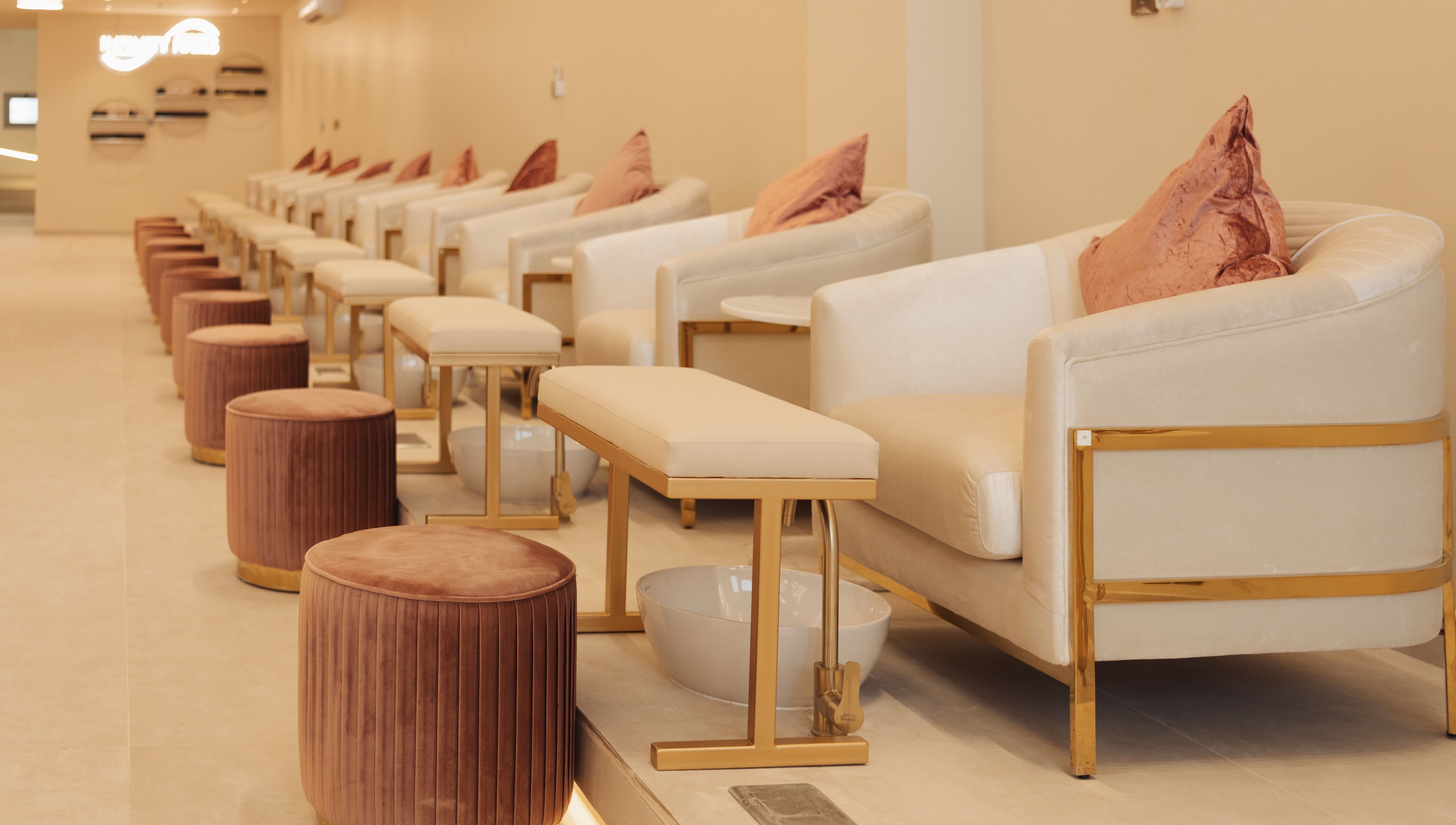 Infinity Nails interior with plush seating in Riyadh, Riyadh Province, SA offering premium nail services.