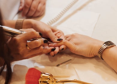Nail technician at Infinity Nails, Riyadh, performing intricate manicure detail.