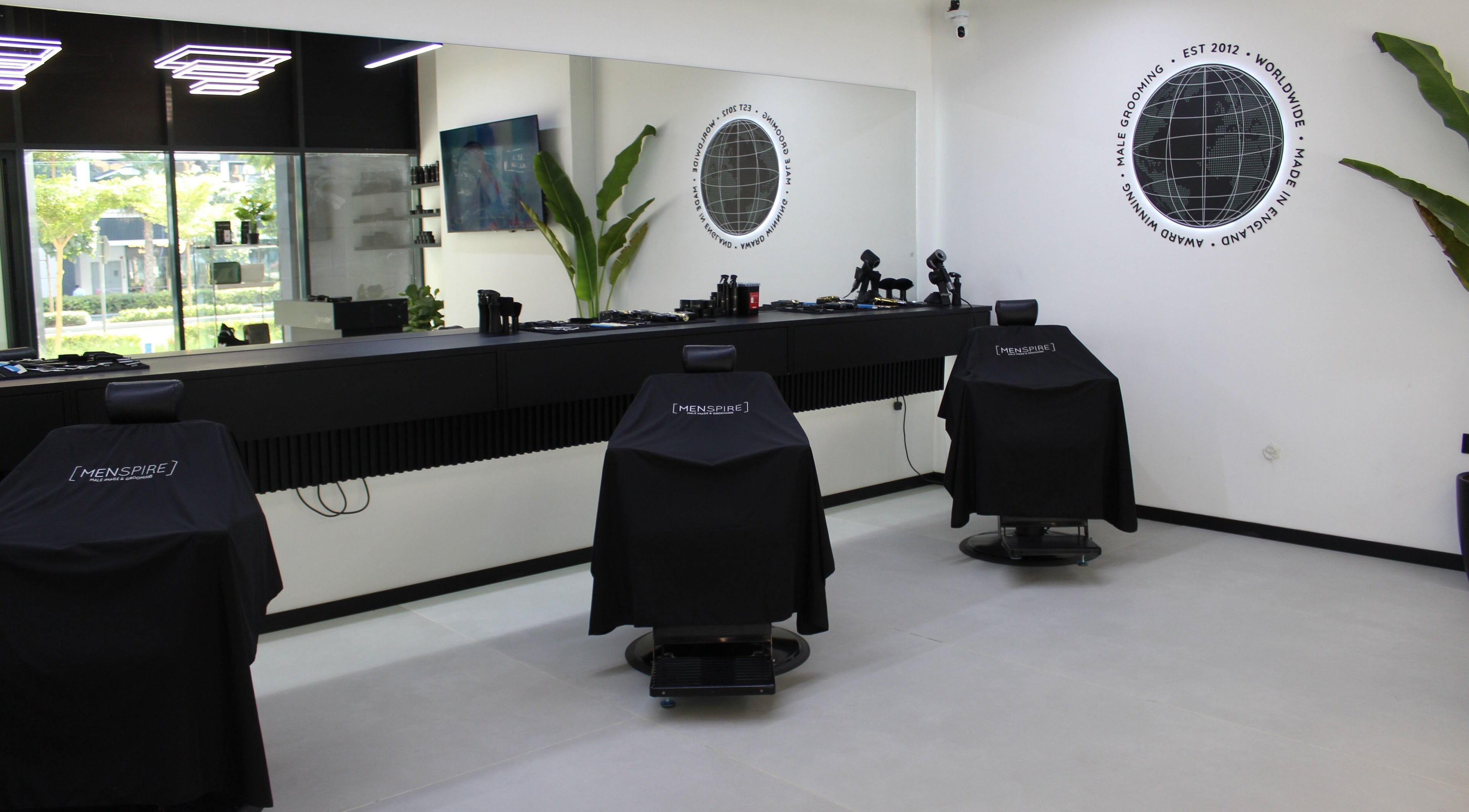 Modern interior of Menspire Dubai barber shop in Dubai, Dubai, AE, featuring sleek design and grooming chairs.