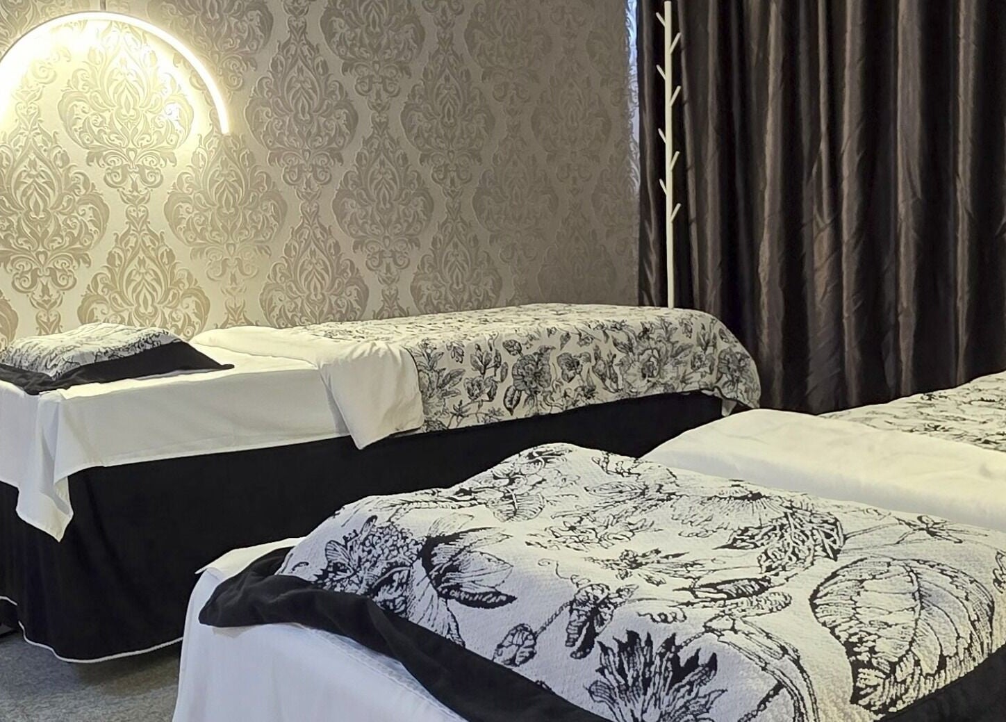 Elegant spa room at Joie's Studio, Singapore, SG with floral bedding and ambient lighting.