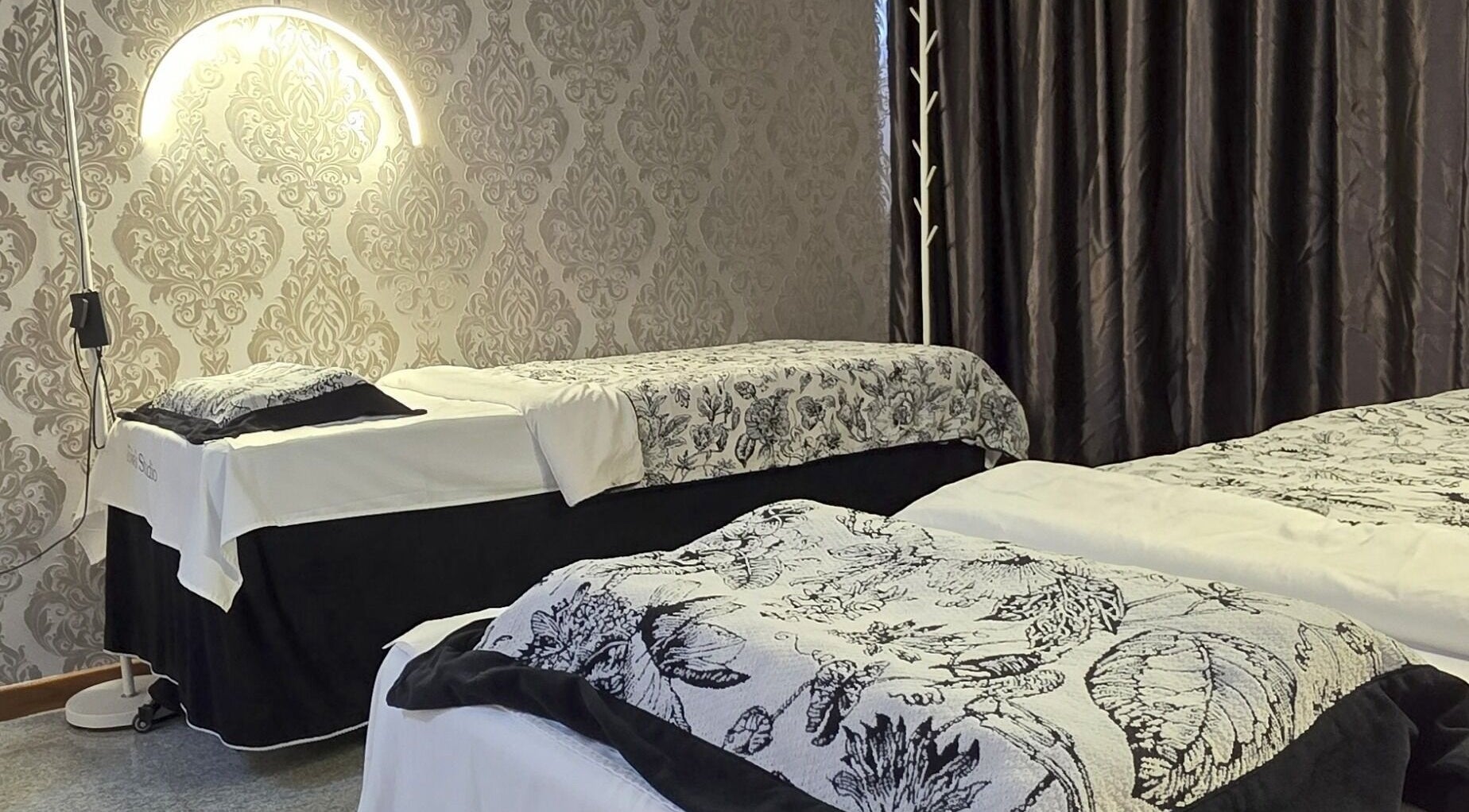 Elegant spa room at Joie's Studio, Singapore, SG with floral bedding and ambient lighting.