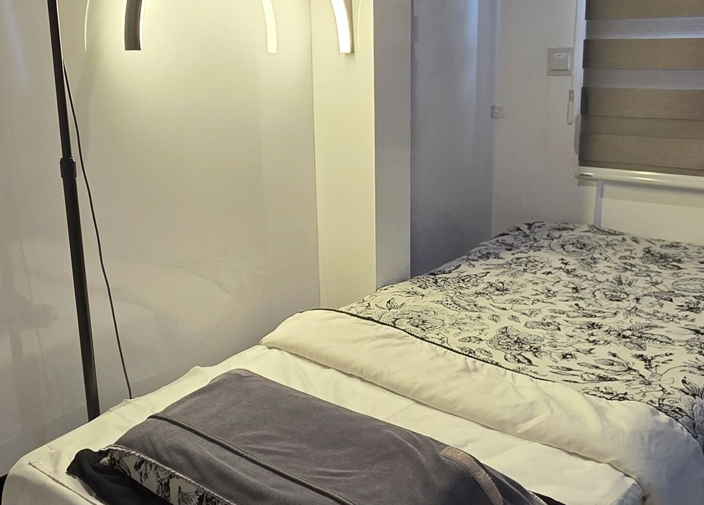 Peaceful spa room at Joie's Studio, Singapore, SG, featuring a cozy bed and soft lighting.