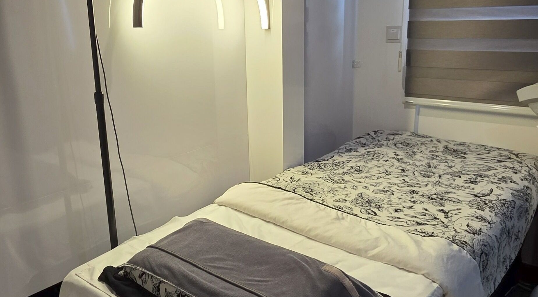 Peaceful spa room at Joie's Studio, Singapore, SG, featuring a cozy bed and soft lighting.