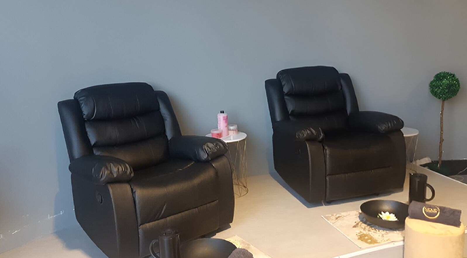 Relaxing seating area at Mood Beauty CPT, Cape Town, Western Cape, ZA with plush black chairs and calming decor.