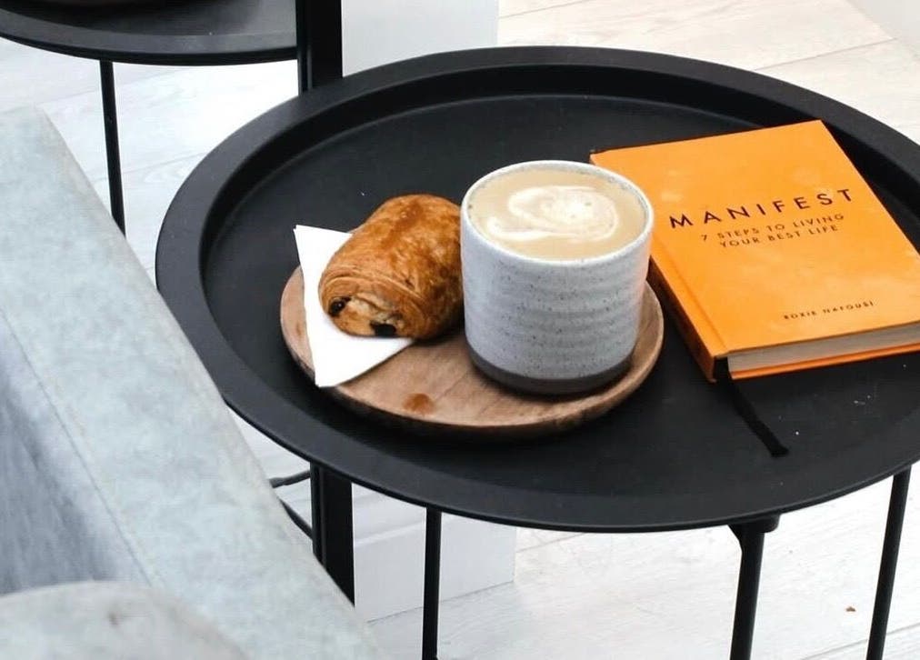 Relaxing coffee setup at Hair by Izzy, Harrogate, England, GB with a book and pastry.