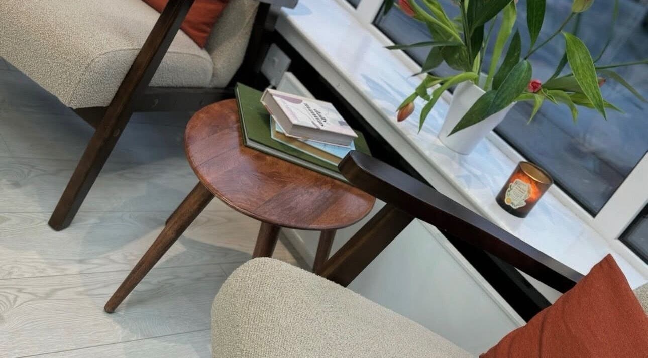 Cozy seating area at Hair by Izzy, Harrogate, England, GB, featuring elegant decor and comfortable furniture.