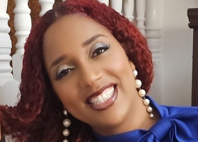 Smiling woman with vibrant hair at Saloon Cornucopia, Nassau, New Providence, BS.