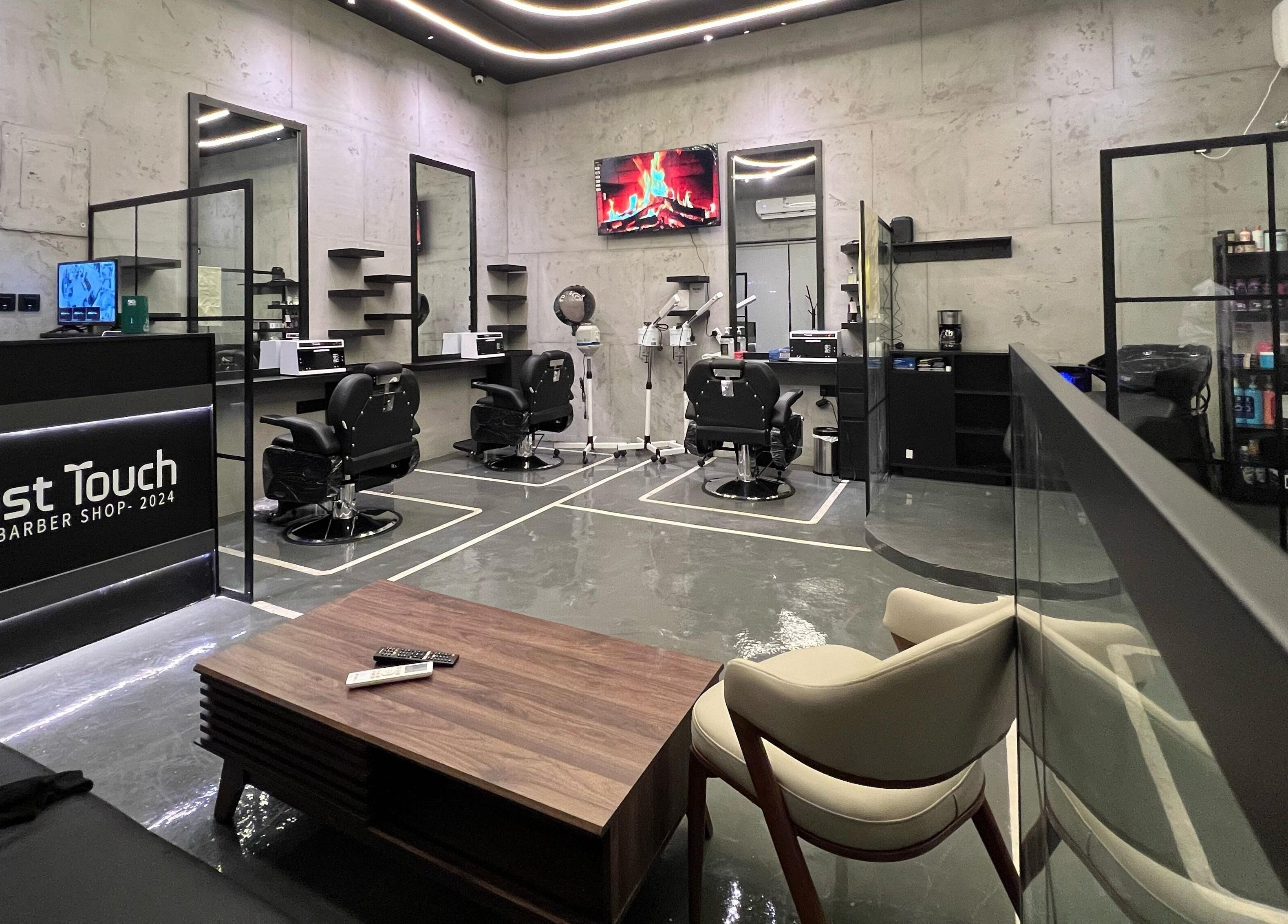 تصميم داخلي أنيق لصالون Last Touch في الرياض، الرياض، SA مع كراسي وأدوات حلاقة حديثة.