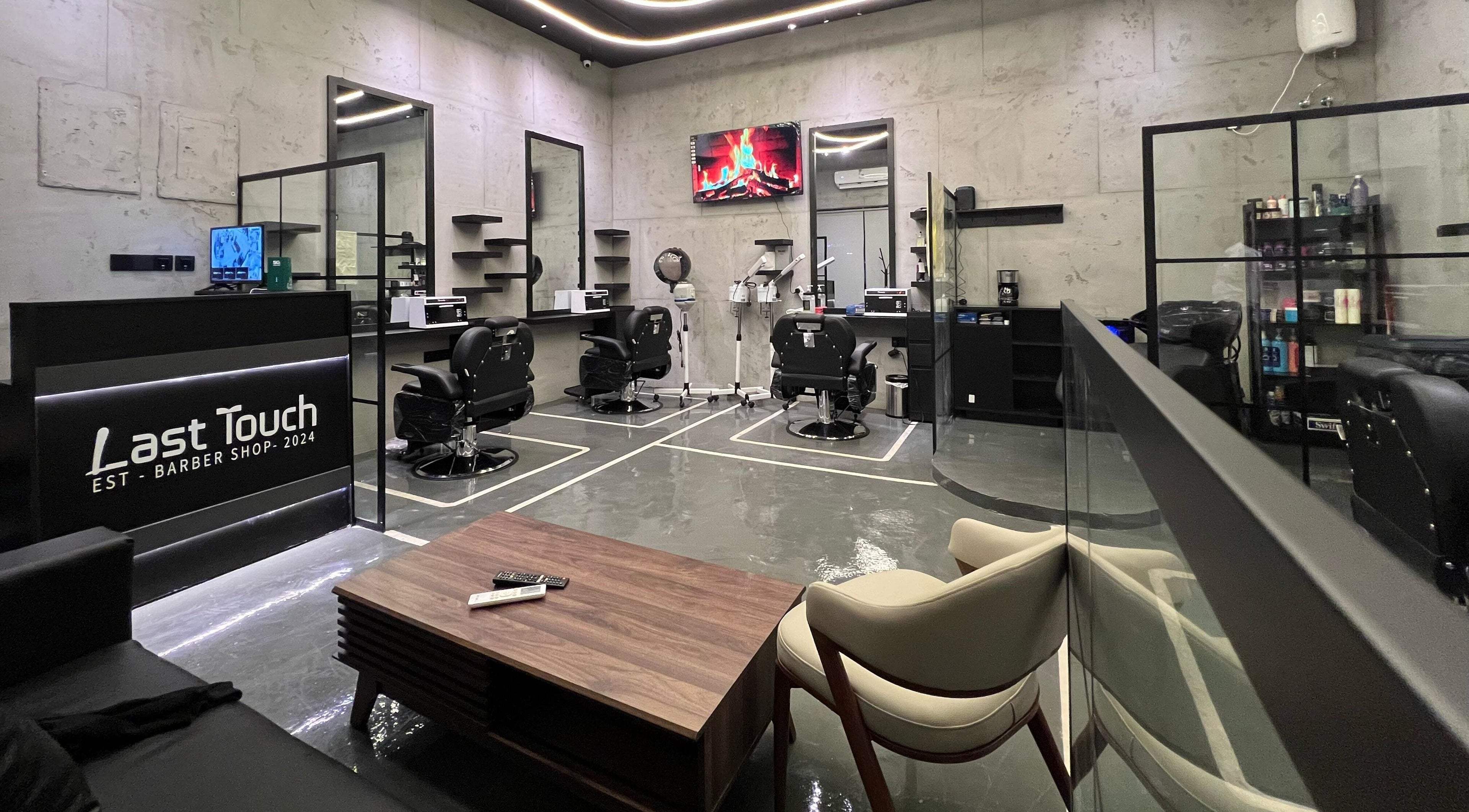 تصميم داخلي أنيق لصالون Last Touch في الرياض، الرياض، SA مع كراسي وأدوات حلاقة حديثة.