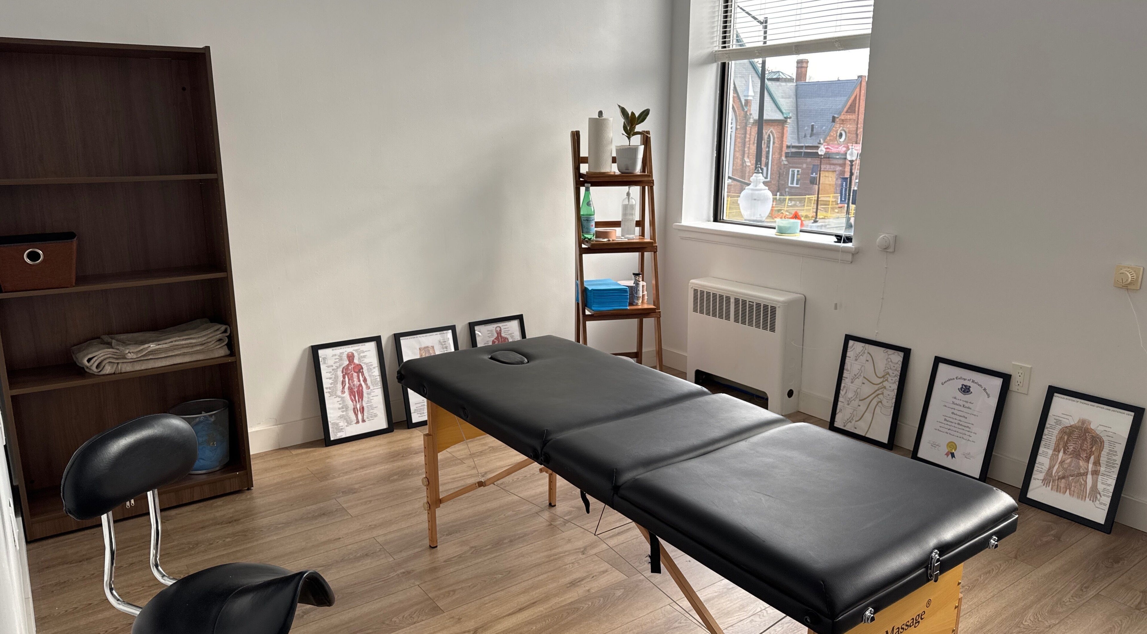Relaxing therapy room at Classical Osteopathy Centre Oakville, Ontario, CA with massage table and decor.