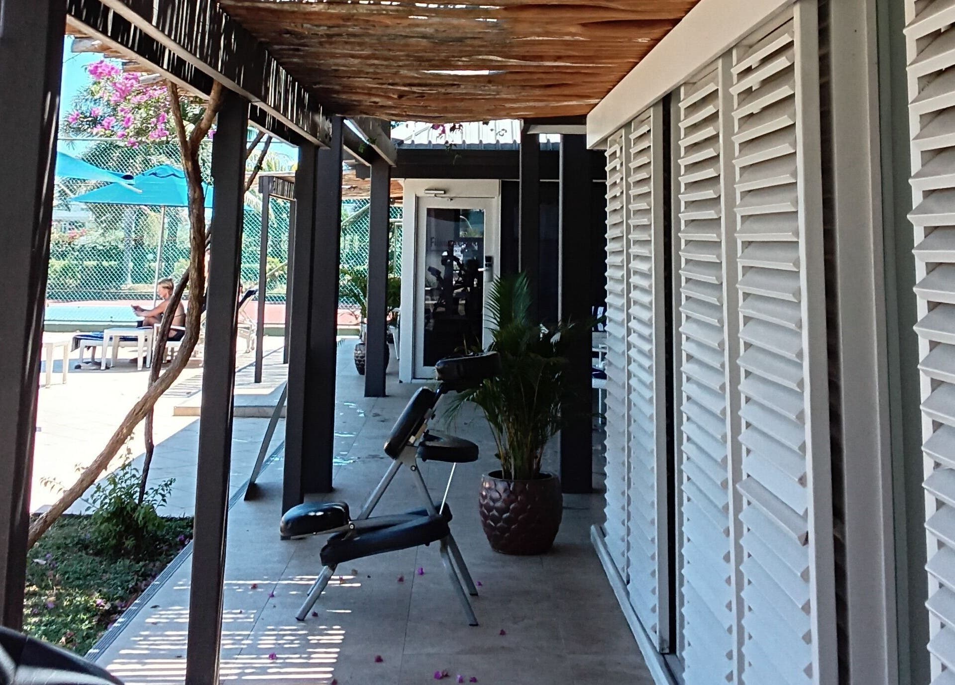 Outdoor relaxation at Nama Fiji's shaded patio in Nadi, Western Division, FJ, featuring lounge chairs and greenery.