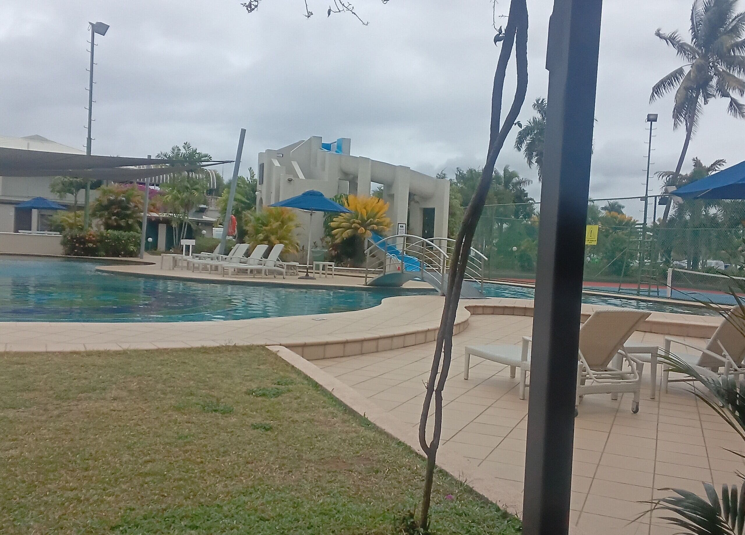 Serene poolside at Nama Fiji in Nadi, Western Division, FJ, featuring loungers and lush greenery.