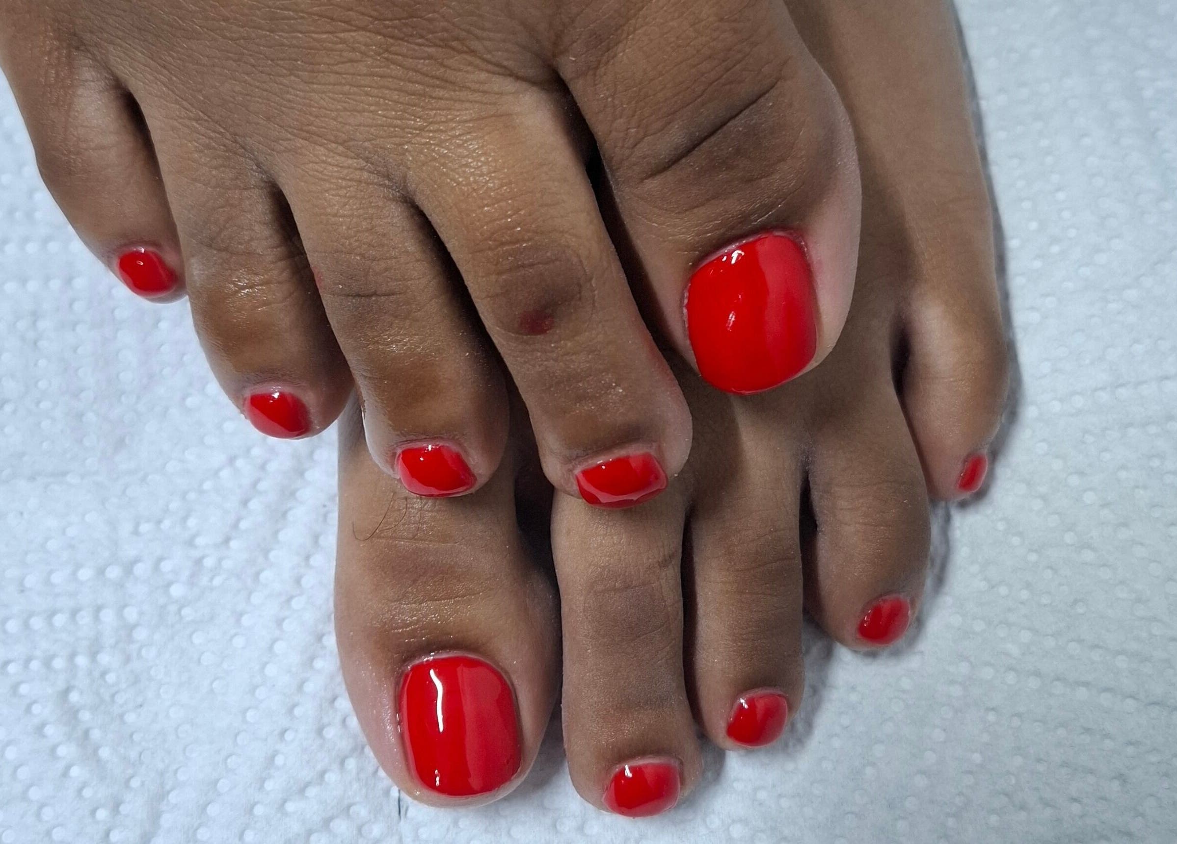 Freshly painted red toenails at House of Nails, Cape Town, Western Cape, ZA, showcasing expert pedicure service.