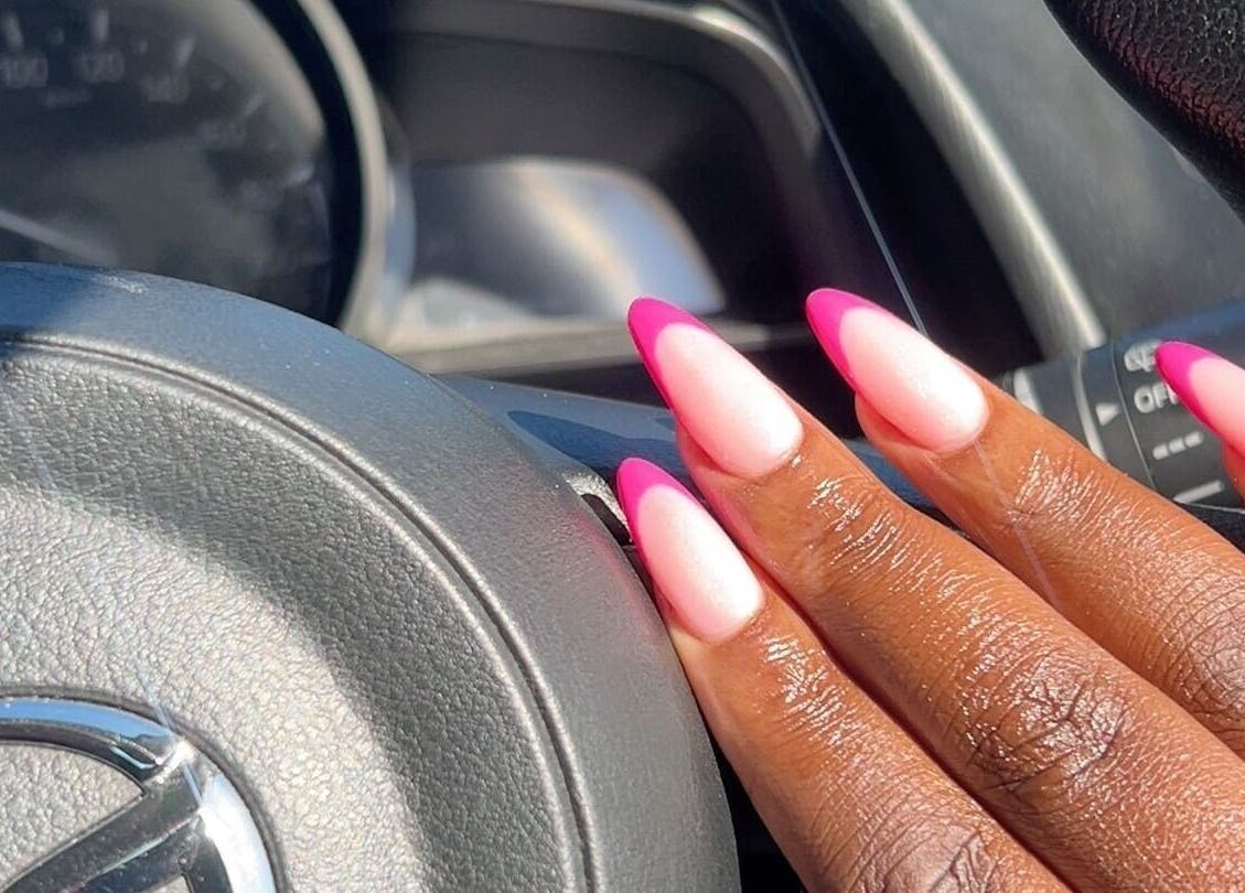 Elegant pink nails designed at House of Nails in Cape Town, Western Cape, ZA, on a car steering wheel.