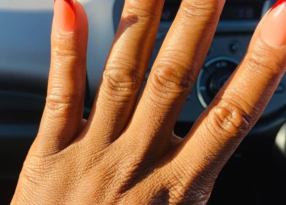Hand with stylish red nails designed at House of Nails, Cape Town, Western Cape, ZA.