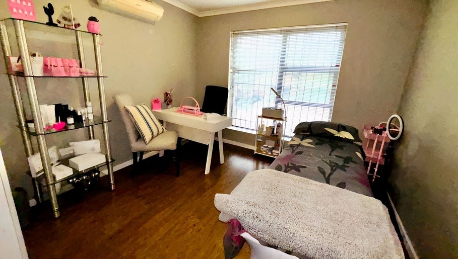 Relaxing treatment room at Make Me Pretti‎ in Cape Town, Western Cape, ZA with bed and beauty products displayed.